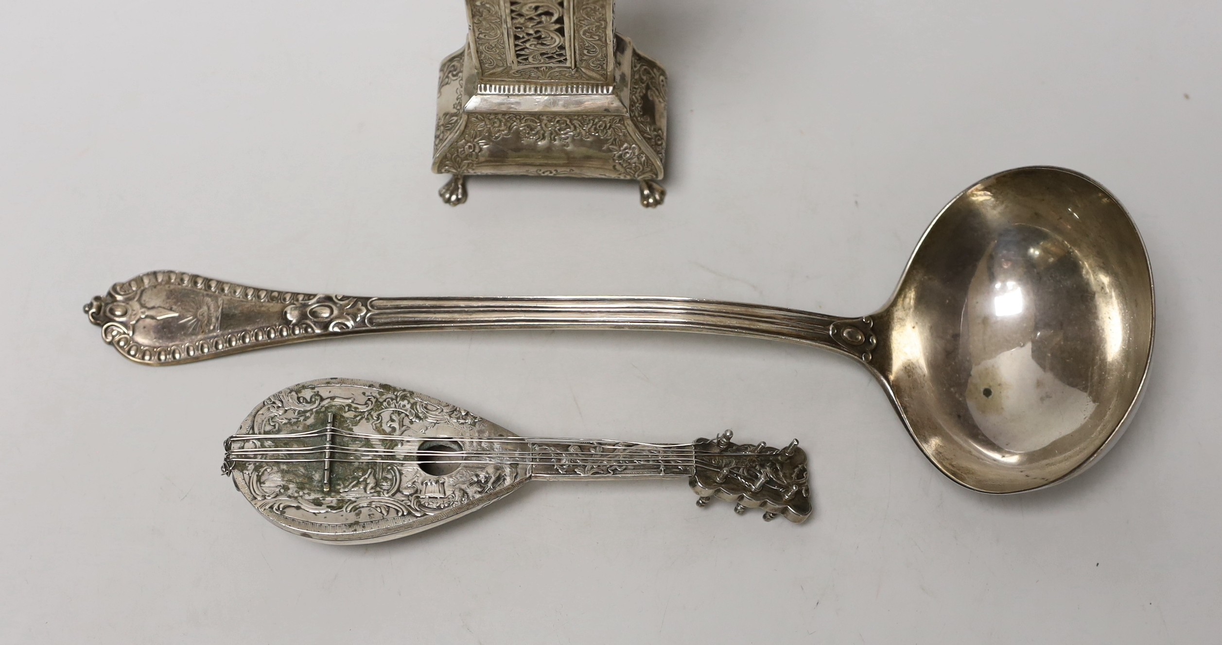 A Dutch white metal miniature longcase clock, 23.8cm, a similar model of a mandolin and a Victorian silver soup ladle by George Adams.